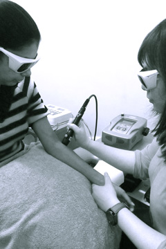 photo of chiropractor performing LASER therapy treatment of wrist pain